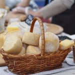Cheese in a wicker basket on the market counter. Food